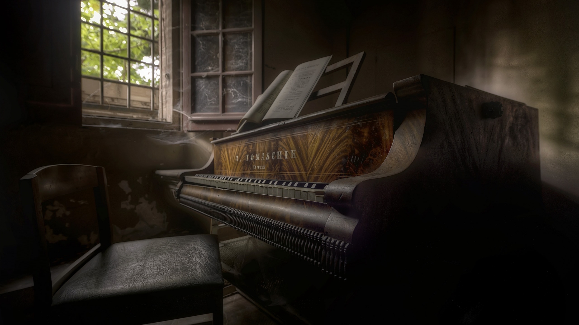 An antique piano illuminated beside an open window