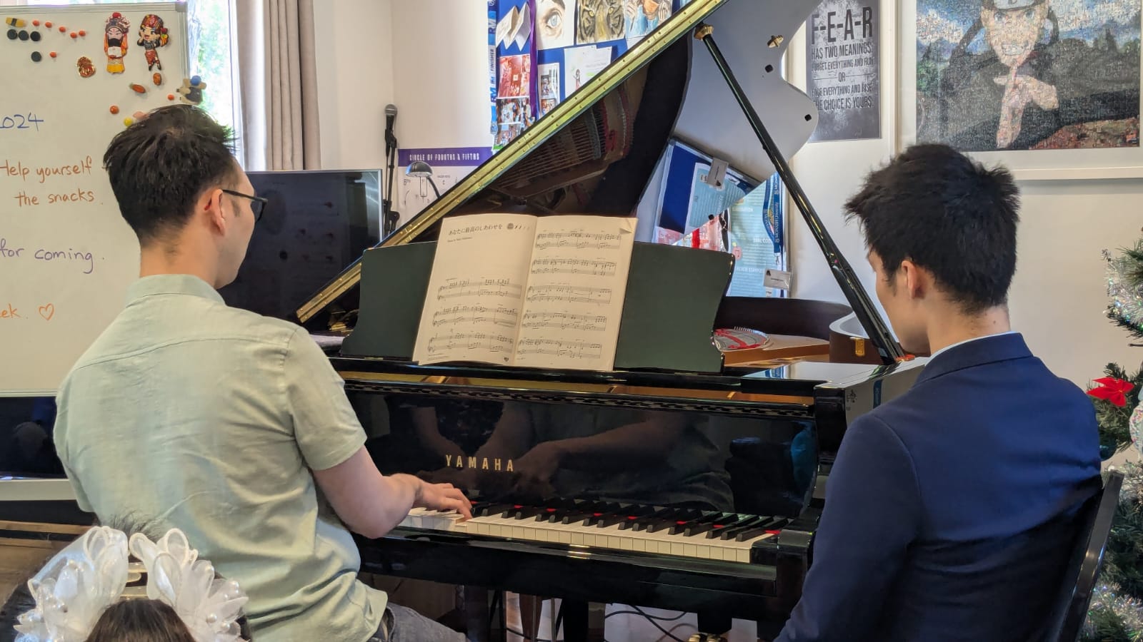Hanford teaching a student at the piano